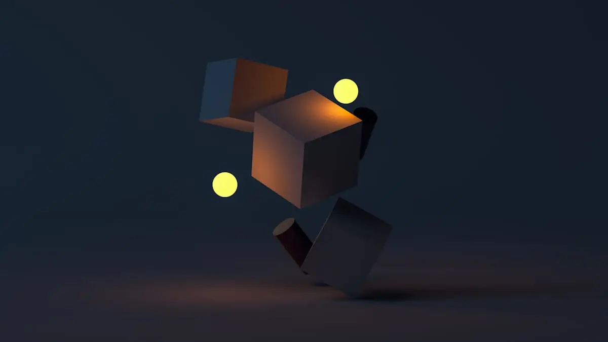 Abstract geometric sculpture lit against a dark background